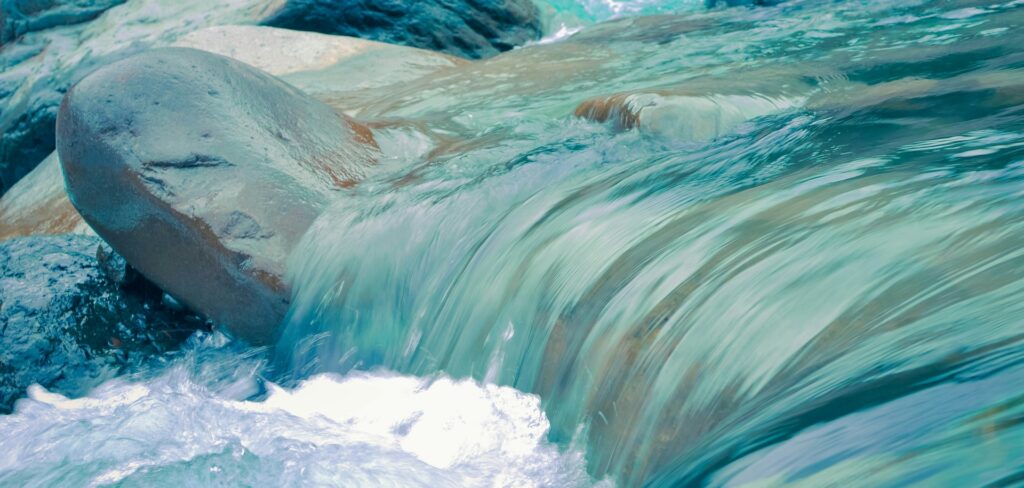 A crystal clear stream flows over rocks